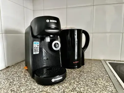 a coffee maker sitting on a counter next to a cup at Yialos Village by Cybarco in Larnaka