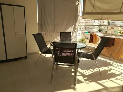 a table and chairs in a room with a window at alfaro57 in Nicosia