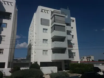 a tall white building with balconies on it at alfaro57 in Nicosia