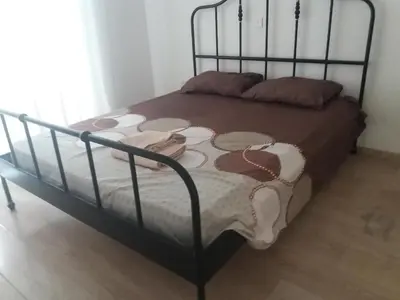 a bed with a black frame and a bed with shoes on it at alfaro57 in Nicosia