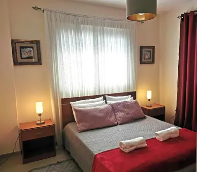 a bedroom with a bed with two towels on it at Holiday apartment in Kyklades Complex with gym&pool in Paralimni