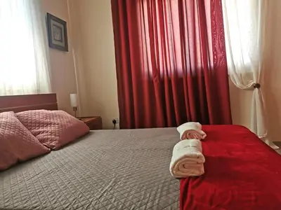 a bedroom with a bed with towels on it at Holiday apartment in Kyklades Complex with gym&pool in Paralimni