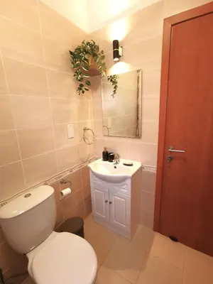 a bathroom with a toilet and a sink at Holiday apartment in Kyklades Complex with gym&pool in Paralimni