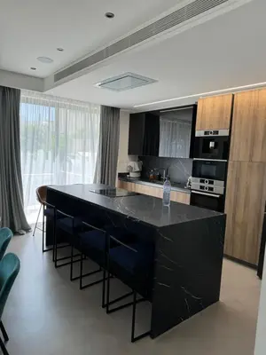 a kitchen with a black island in a room at Larnaca Centre Villa in Larnaka