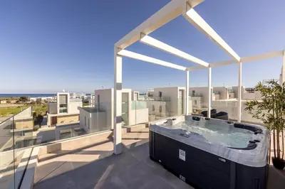 a hot tub on the balcony of a building at Protaras Bay View Villa 11 in Protaras