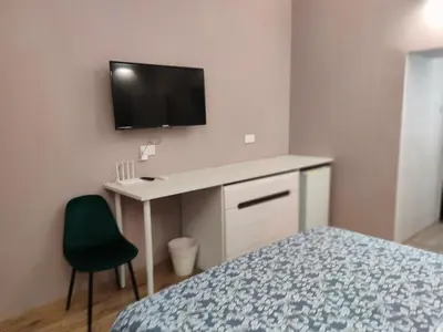 a bedroom with a desk and a tv on the wall at Studio in the centre of Nicosia 2 in Nicosia