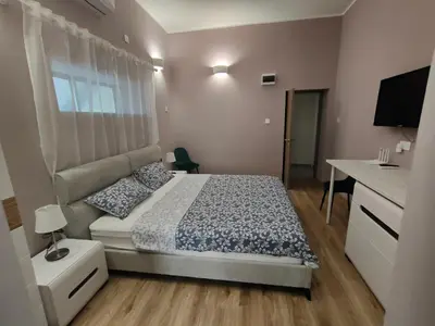 a bedroom with a bed and a desk and a television at Studio in the centre of Nicosia 2 in Nicosia