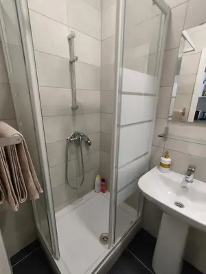 a shower with a glass door next to a sink at Studio in the centre of Nicosia 2 in Nicosia