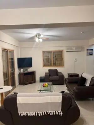 a living room with a couch and a tv at Palm Villa 3 bedrooms - Sleeps 6 in Ayia Napa