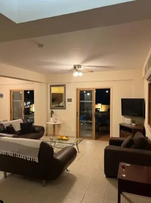 a living room with a couch and a tv at Palm Villa 3 bedrooms - Sleeps 6 in Ayia Napa