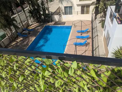 a swimming pool with chairs and a fence at Kiti 2 bedroom Penthouse in Kiti