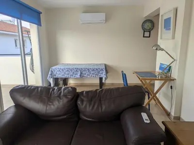 a living room with a leather couch and a table at Kiti 2 bedroom Penthouse in Kiti
