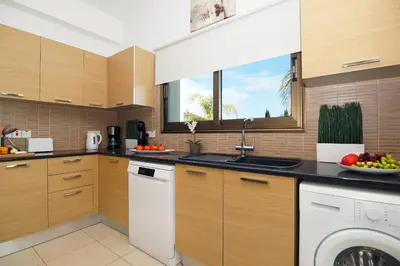 a kitchen with a sink and a dishwasher at Villa Merry in Ayia Napa