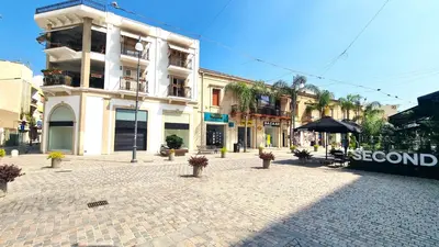 a cobblestone street in front of a building at Lovely 1BR in Old Town - City Center & 4min to Beach in Scala