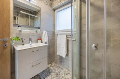 a bathroom with a sink and a shower at 74 Prokymea- Steps from the Sea, Downtown, Balcony in Limassol
