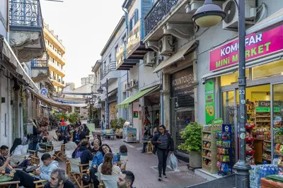 a group of people sitting at tables in a street at 74 Prokymea- Steps from the Sea, Downtown, Balcony in Limassol