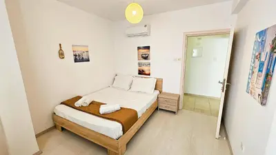 a small bedroom with a bed and a bathroom at Seaside Comfort Residence in Larnaka