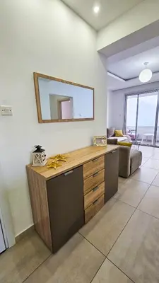 a room with a counter with a mirror on the wall at Seaside Comfort Residence in Larnaka