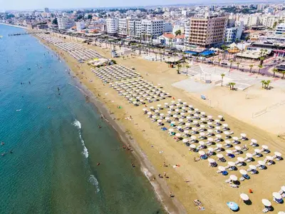 an aerial view of a beach with umbrellas and the ocean at Seaside Comfort Residence in Larnaka