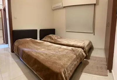 two beds with brown covers in a room at Cozy comfortable 2-bedroom apartment in Limassol