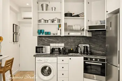 a kitchen with a washer and a washer and dryer at Lazuli Hermes Apartments in Larnaka