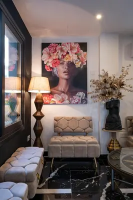 a living room with a painting of a woman on the wall at Lazuli Hermes Apartments in Larnaka