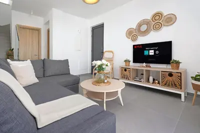 a living room with a couch and a tv at Villa Clio - 3bed All En-suite with Private Pool in Paralimni