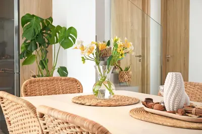 a dining room table with a vase of flowers at Villa Clio - 3bed All En-suite with Private Pool in Paralimni