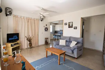 a living room with a couch and a table at Merab Center Villas in Ayia Napa