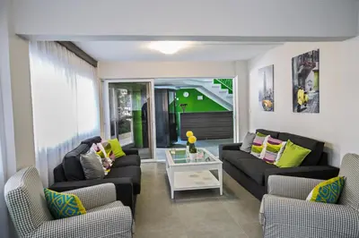 a living room with two couches and a table at Merab Napa Suites in Ayia Napa