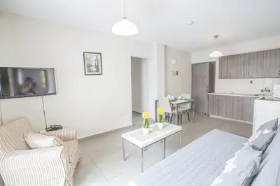 a living room with a couch and a table at Merab Napa Suites in Ayia Napa
