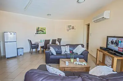 a living room with two couches and a tv at Napiana Apartments in Ayia Napa
