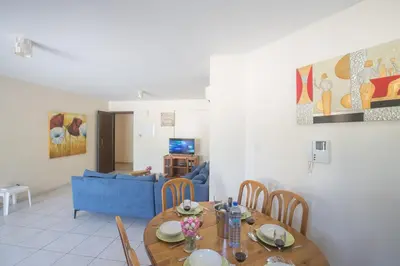 a living room with a table and a blue couch at Napiana Apartments in Ayia Napa