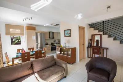 a living room with a couch and a kitchen at Katerina Luxury Villas in Protaras