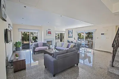 a large living room with couches and a fireplace at Delfini Villas in Protaras