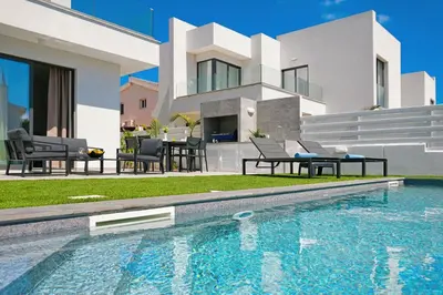 a house with a swimming pool in front of a house at Villa Flora - 3Bed all En-suite with Private Pool in Paralimni