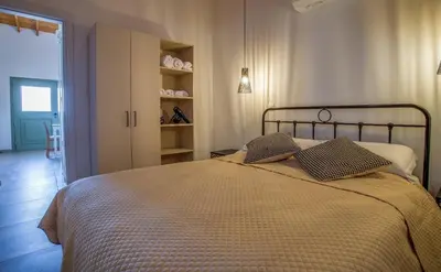 a bedroom with a bed with two pillows on it at Eleonas Seaview Cottages in Alaminos