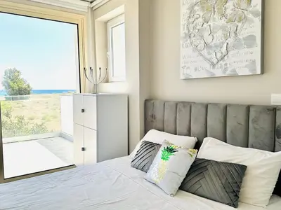a bedroom with a bed and a large window at Luxury Villa LAPIS LAZULI in Meneou