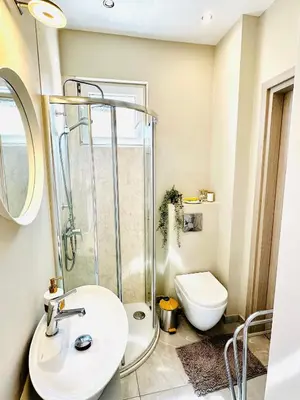 a bathroom with a shower and a sink and a toilet at Luxury Villa LAPIS LAZULI in Meneou