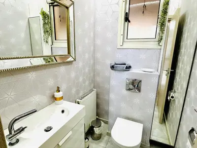 a bathroom with a toilet and a sink and a mirror at Luxury Villa LAPIS LAZULI in Meneou