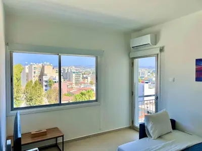 a room with a couch and a large window at Cristiana Sea Breeze, Sleeps 3, Free Wifi in Limassol
