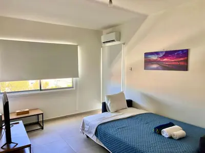 a bedroom with a blue bed and a window at Cristiana Sea Breeze, Sleeps 3, Free Wifi in Limassol