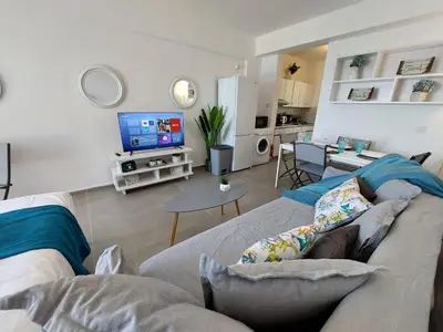 a living room with a couch and a tv at JUST on the beach Makenzy Studio in Scala