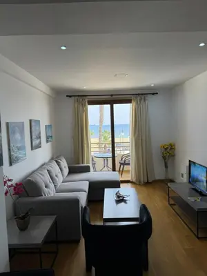 a living room with a couch and a table at Ithaki Phinikoudes Apartment No. 102 in Larnaka