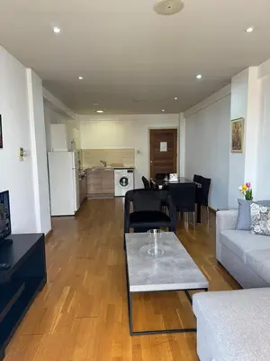 a living room with a couch and a table at Ithaki Phinikoudes Apartment No. 105 in Larnaka