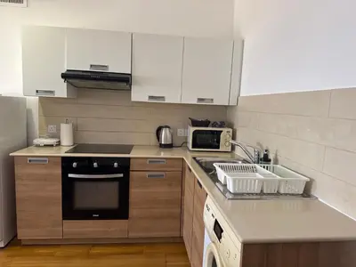 a kitchen with a sink and a microwave at Ithaki Phinikoudes Apartment No. 202 in Larnaka