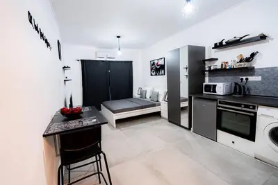 a kitchen with a sink and a stove top oven at Hubstay - Klea's Downtown City Apartment Suite in Larnaka