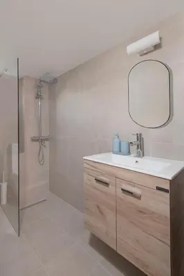 a bathroom with a sink and a shower with a mirror at Amazing Sea View and Location in Scala