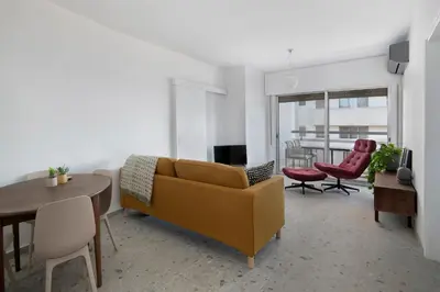 a living room with a couch and a table and chairs at Amazing Sea View and Location in Scala