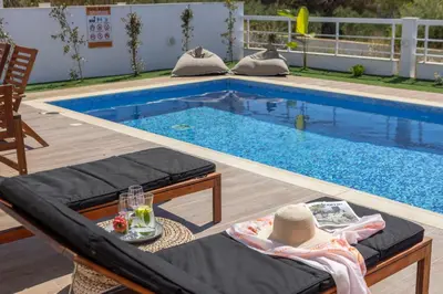 a swimming pool with a table and chairs next to it at Ayia Napa Bay View Villa 5 in Ayia Napa